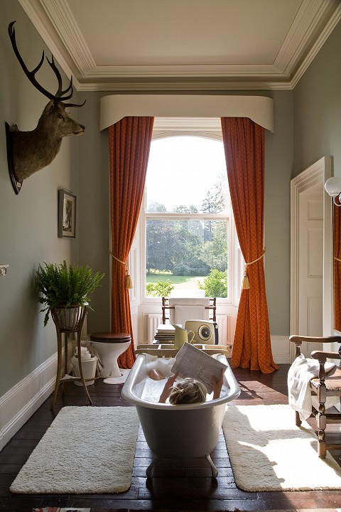 Reading a magazine in the antique roll top bath