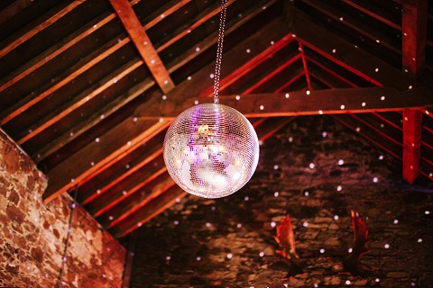 Glitterball in the rustic stone barn wedding venue